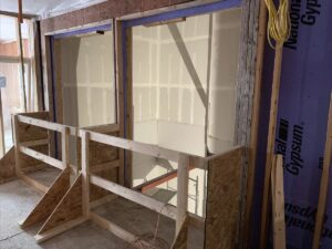 Elevator shaft sheetrock work prior to installation of elevators.